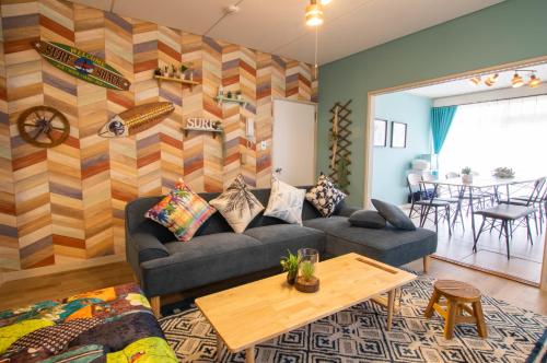 a living room with a couch and a table at Villent Kujukuri Ocean 1 in Kujukuri