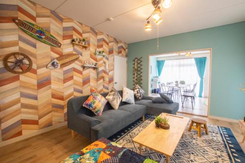 a living room with a couch and a table at Villent Kujukuri Ocean 1 in Kujukuri