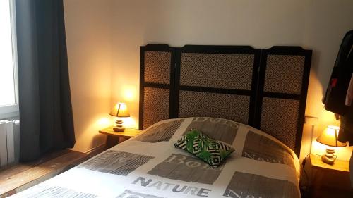 a bedroom with a large bed with two lamps at La Casa Loka, T3 idéalement situé, Port de Vannes in Vannes