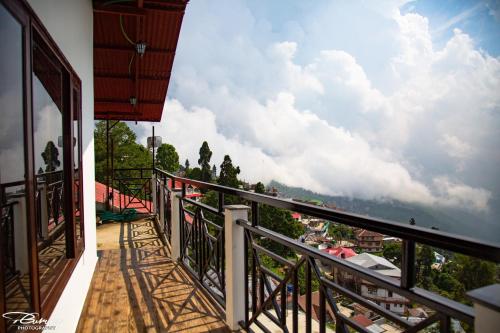 a balcony with a view of the sky at Dreamhome Stay in Kurseong