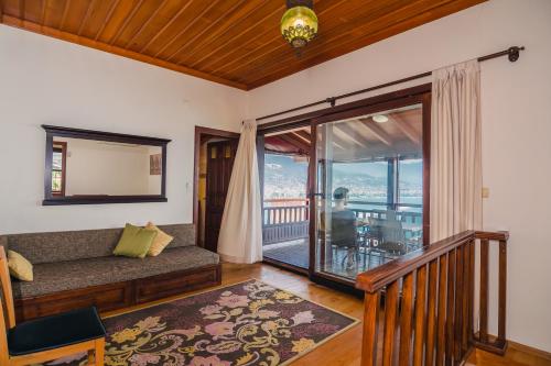 a living room with a couch and a balcony at Hotel Villa Turka in Alanya