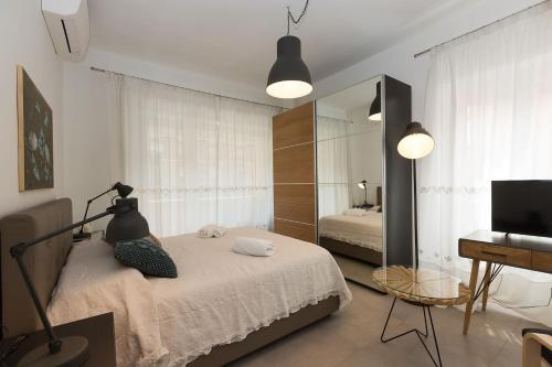 a bedroom with a bed and a mirror and a television at Lovely New Apartament, Viale Trastevere in Rome