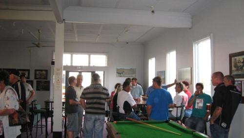 a group of people standing around a pool table at Essex Arms in Huntly