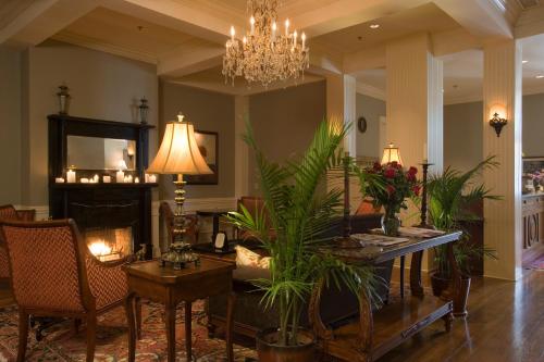 a living room with a chandelier and a table with plants at River Inn of Harbor Town in Memphis