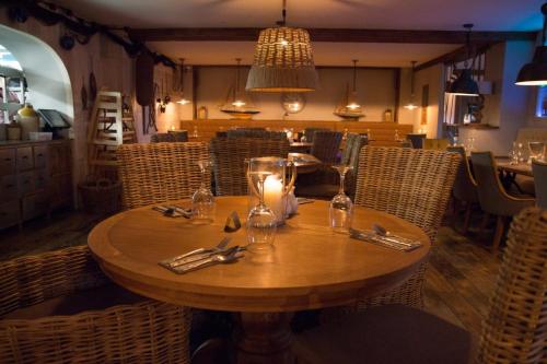 a wooden table in a restaurant with a candle on it at The Dunes Hotel in Barrow in Furness