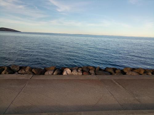 a large body of water with rocks on the shore at Mustapha 2 in Nador