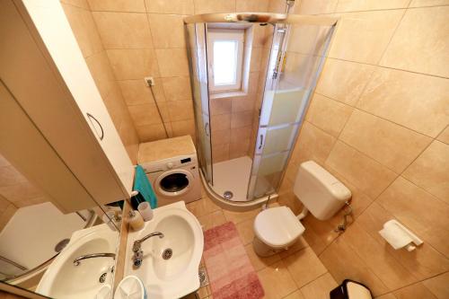 a bathroom with a shower and a sink and a toilet at Apartments Anka in Rtina
