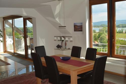 comedor con mesa de madera y sillas en Ferienwohnung Seeblick, en Radolfzell am Bodensee