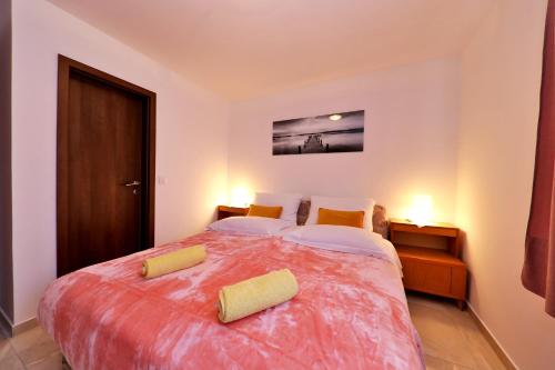 a bedroom with a large bed with two pillows at Apartments Anka in Rtina