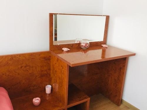 a wooden dressing table with a mirror on it at Casa Kito in Constanţa