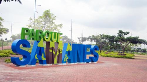 a sign that says papuosity says saps in a park at NCG SUITE SAMANES in Guayaquil