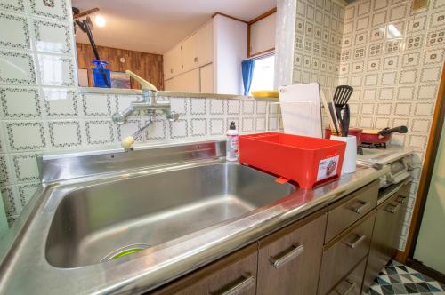 a kitchen sink with a red box on top of it at Villent Kujukuri Ocean 2 in Kujukuri