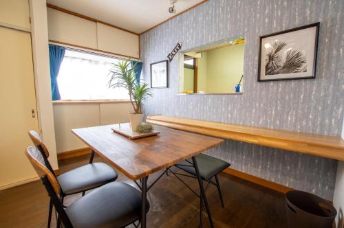 a dining room with a wooden table and chairs at Villent Kujukuri Ocean 2 in Kujukuri