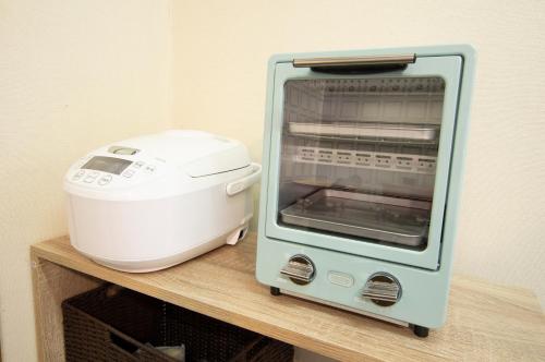 a toaster oven sitting on top of a counter at Villent Kujukuri Ocean 2 in Kujukuri