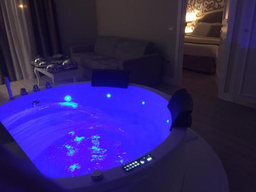 a hot tub in a living room with blue lights at Suites & Apartments Liola' in Castrocielo