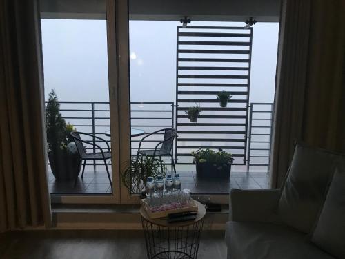 a living room with a table and chairs on a balcony at Apartament przy Aquaparku w Redzie in Rumia