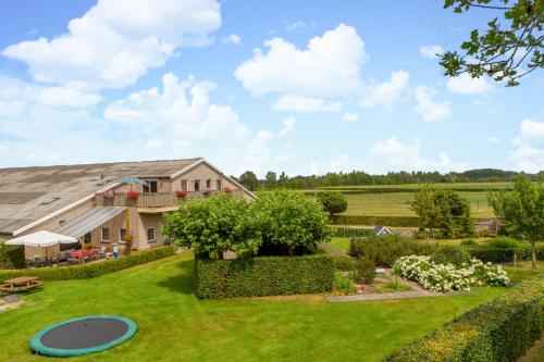 an estate with a large yard with a frisbee at Lenthe Farm Lodge in Dalfsen