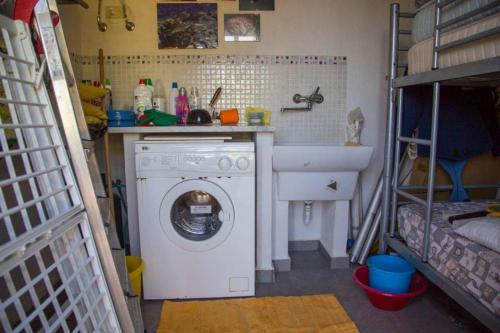 a laundry room with a washing machine and a sink at casa delle palme in Ustica