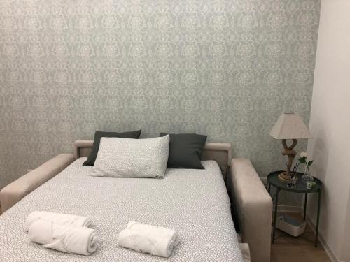 a bed with two pillows on it in a bedroom at Antico Palazzo Lago Maggiore in Verbania