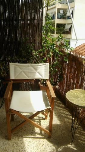 a white bench and a table and a fence at CHRYSSA - ΧΡΥΣΑ in Patra