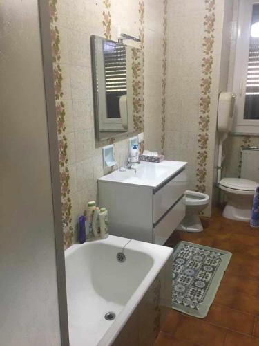 a bathroom with a tub and a sink and a toilet at Betti 21 in Rapallo