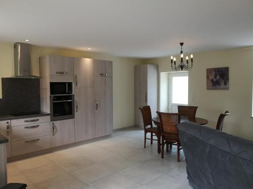 a kitchen and dining room with a table and chairs at Les gites Haras Del Paradiso in Boitron