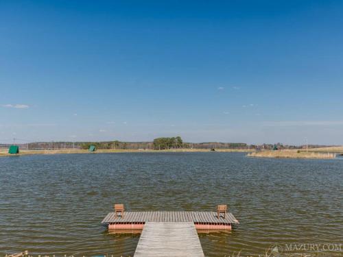 a dock in the middle of a large lake at Sterla - Masuria in Giżycko