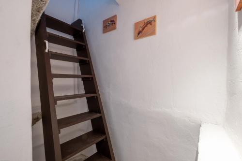 a staircase in a room with a white wall at Labyrinth Traditional Houses in Pirgos