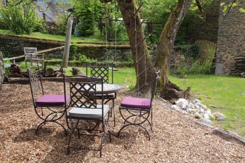 a group of chairs and a table with purple seats at L'Eaubergerine in Herbeumont