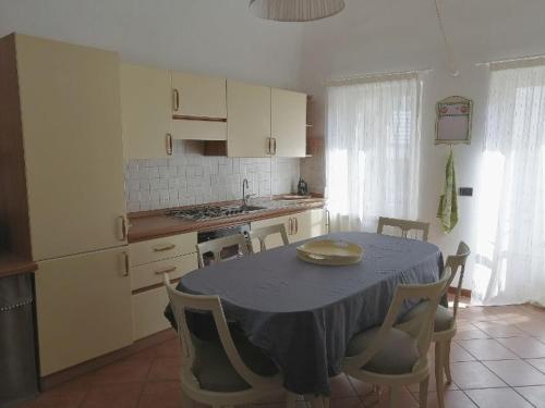 a kitchen with a table and chairs and a kitchen with a table and a kitchen at Pane&Burro in Vercelli