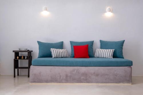 a blue couch with four pillows in a room at Labyrinth Traditional Houses in Pirgos