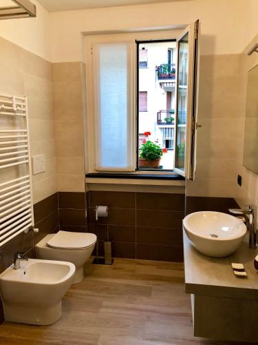a bathroom with a toilet and a sink and a window at Calma di vento in Sestri Levante