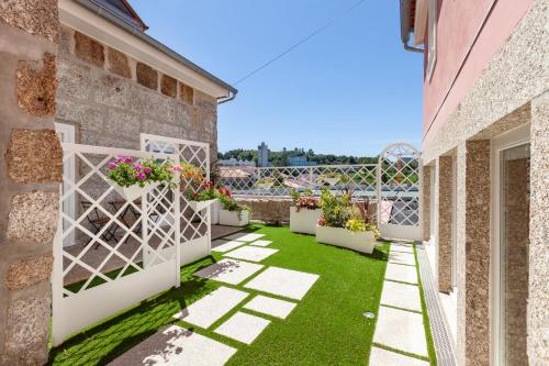 a courtyard with potted plants on a building at Polery Apartments Center in Guimarães