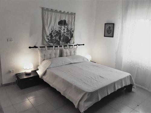 a black and white bedroom with a bed and a window at Tenuta Argiano in Mesagne