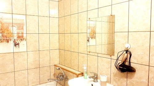 a bathroom with a sink and a mirror at Apartment on Artushkova in Krasnodar