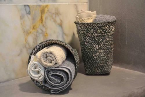 a roll of towels next to a trash can at Aelia Houses in Agia Marina Aegina