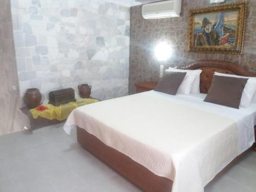 a bedroom with a large bed in a room at Laskas Apartment in Stalida