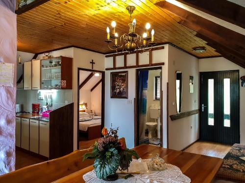 a kitchen and dining room with a dining table at Apartment Franciska in Rakovica