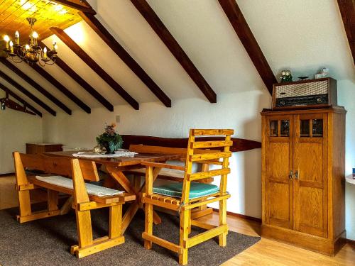 a dining room with a wooden table and chairs at Apartment Franciska in Rakovica