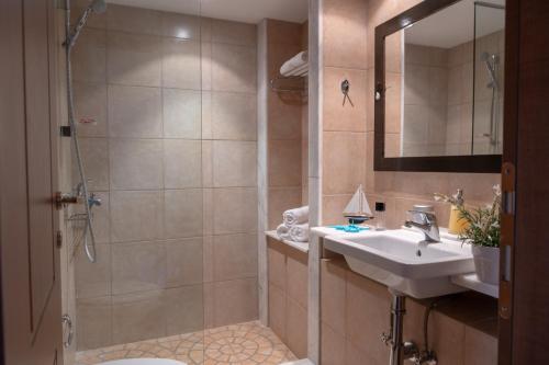 a bathroom with a sink and a shower at Porto Sisi Hotel Apartments in Sissi
