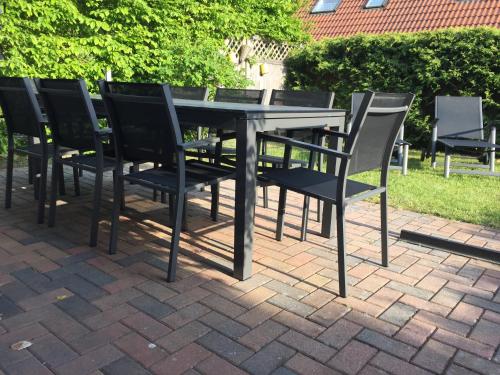 a table and chairs on a brick patio at Meeresbrise in Graal-Müritz