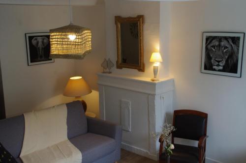 a living room with a couch and a mirror at La Cour Royale in Bayeux
