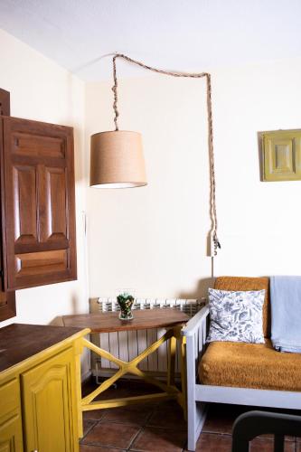 a dining room with a table and a chair at Apartamentos Vista Veleta in Capileira