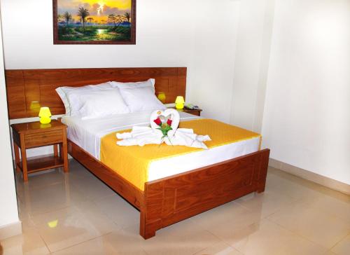 a bedroom with a bed with a towel on it at Del Castillo Plaza Hotel Pucallpa in Pucallpa
