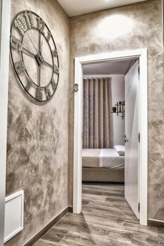 a room with a large clock on the wall at DIMORA FLEGREA room & breakfast in Pozzuoli