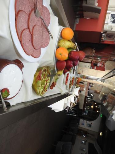 a buffet line with meat and fruits and vegetables at Hill View Hotel Apartments in Pissouri