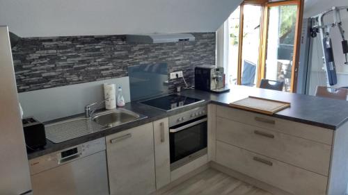 a kitchen with a sink and a counter top at Haus Rebblick in Offenburg