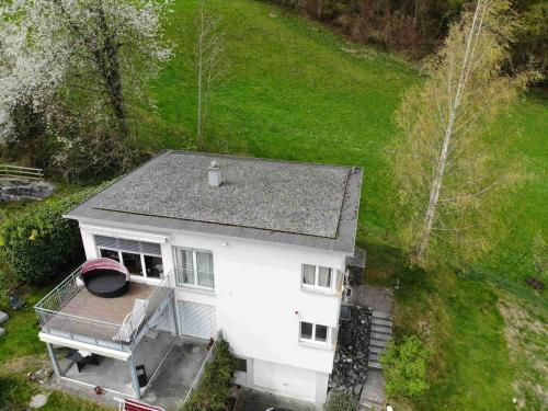 an aerial view of a white house with a porch at Alpen Panorama view Luxury House with green Garden in Buchs