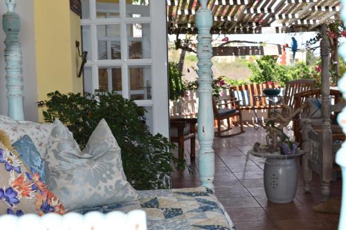 a living room with a couch and tables and chairs at Casa Bonita Inn in La Parguera