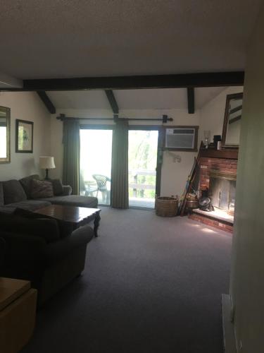 a living room with a couch and a fireplace at 106 Village at Camelback in Tannersville